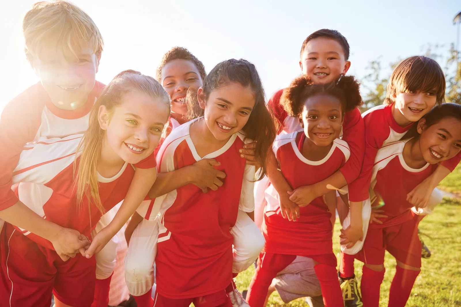 Smiling youth sports team in red uniforms